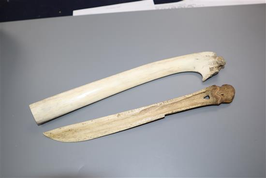 An eskimo scrimshaw elk bone and a similar paper knife,